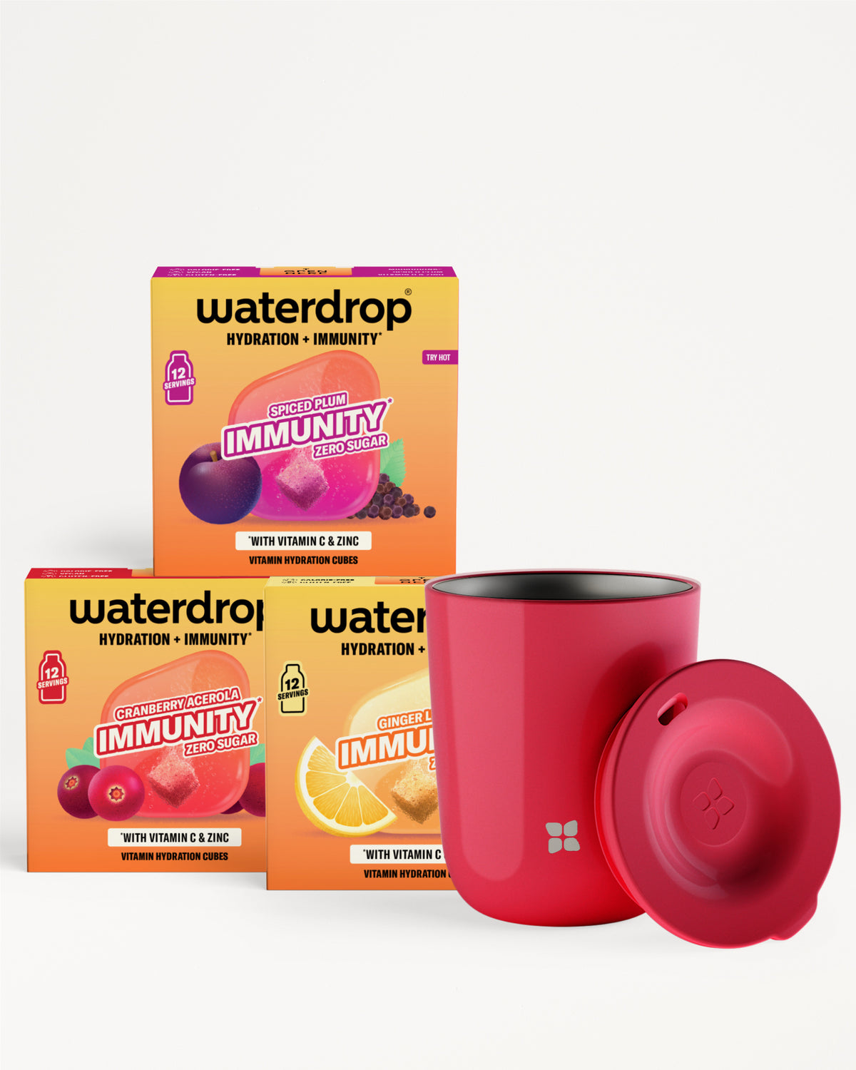 Tri oranžových škatier produktu pre hydratáciu a imunitu so červeným pohárom a viečkom.