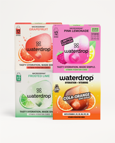 Štyri krabičky Microdrink Waterdrop v príchutiach Grapefruit, Pink Lemonade, Frosted Lime a Cola Orange, umiestnené na bielom pozadí.