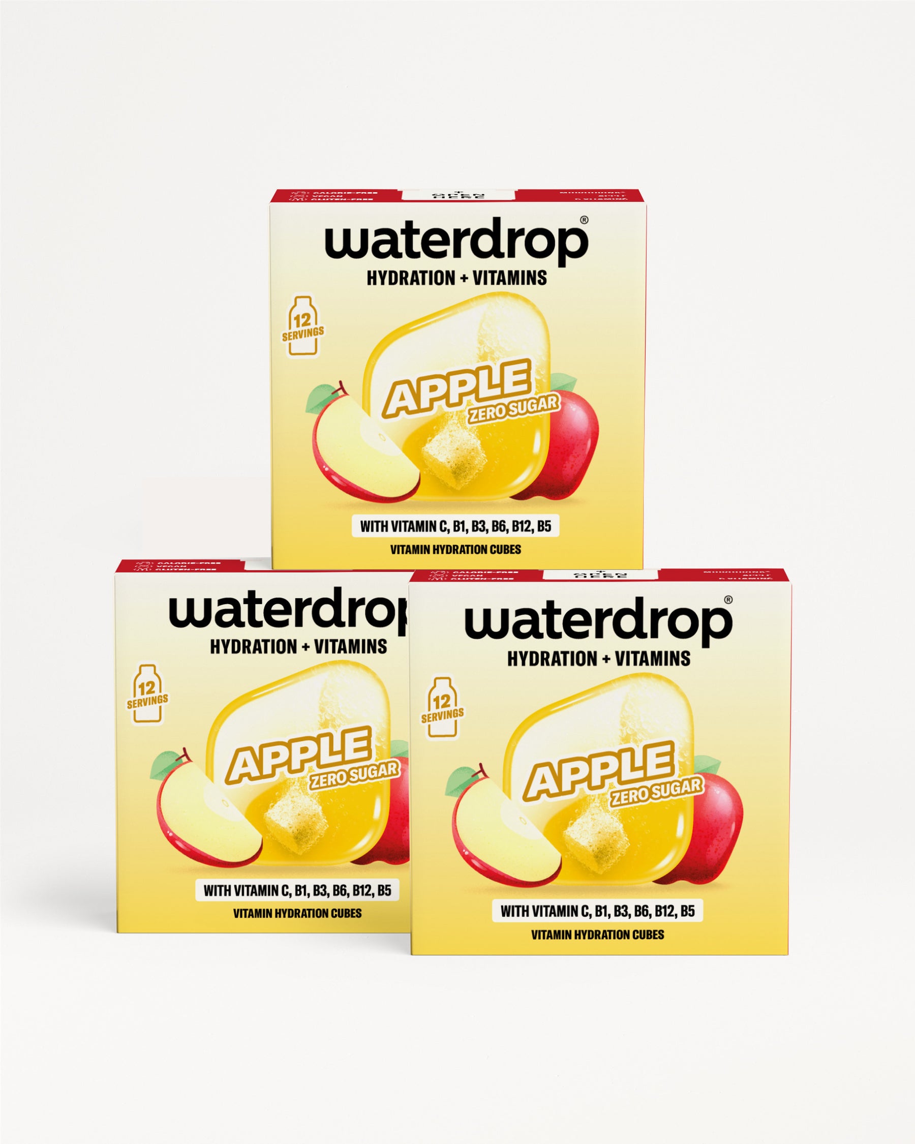 Tri žlté balenia Waterdrop s obrázkom jablka, poskladané do trojuholníka.